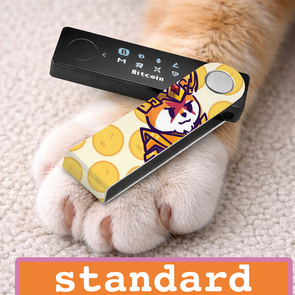 Ledger nano x crypto wallet on top of a cat paw. the nano x is wrapped with a foami walletSkinz sticker of 
NFT Famous Fox Federation project printed in standard art style