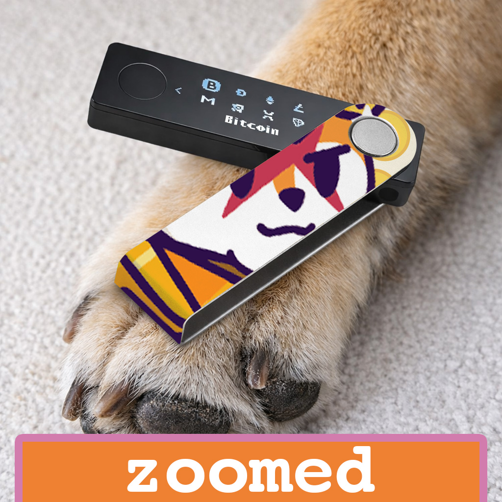 Ledger nano x crypto wallet on top of a cat paw. the nano x is wrapped with a foami walletSkinz sticker of 
NFT Famous Fox Federation project printed in zoomed art style